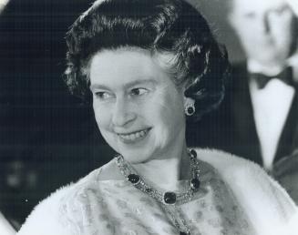 Happy to be here: The Queen smiles as she enters the National Arts Centre in Ottawa last night for a gala