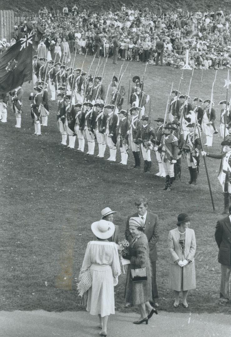 Battle royal: The Queen walks toward the troops who took part in a re-enactment of a revolutionary battle at the Fort Wellington Military Pageant in Prescott yesterday