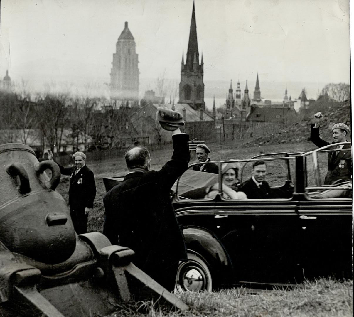 In the lower picture, their majesties are seen driving through a line-up of war veterans on their visit to Quebec