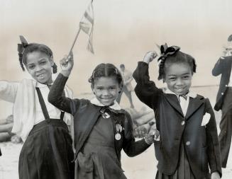 Three little girls wait to greet Queen