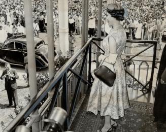 The Princess Waves from a balcony at the civic reception