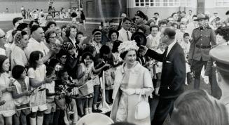 The children cheered lustily for their Queen when she stepped from the plane at Ottawa yesterday-cheers that followed her all the way to official reception