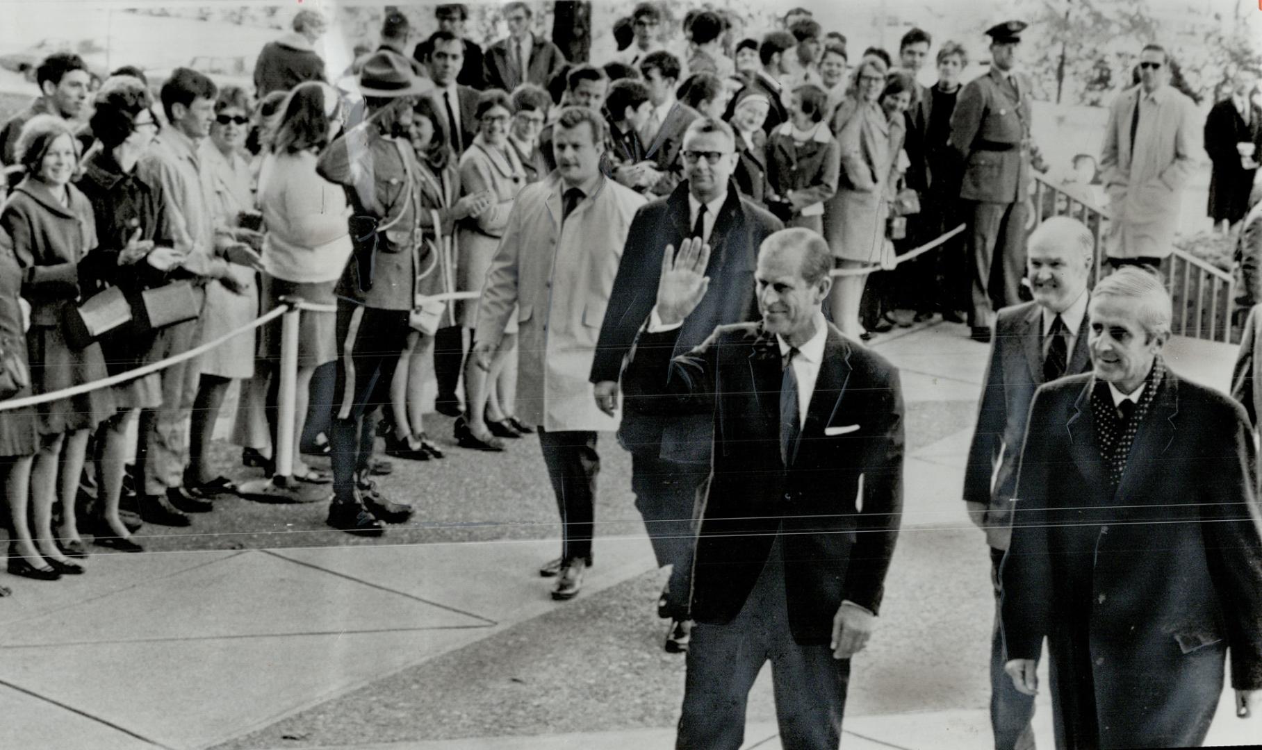 Prince Philip waves to crowds in Ottawa today on his way to look at moon rocks in Department of Mines headquarters