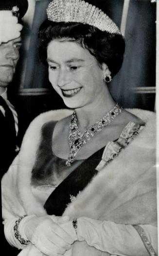 Our radiant Queen captured by the camera as she leaves the State dinner in Charlottetown yesterday