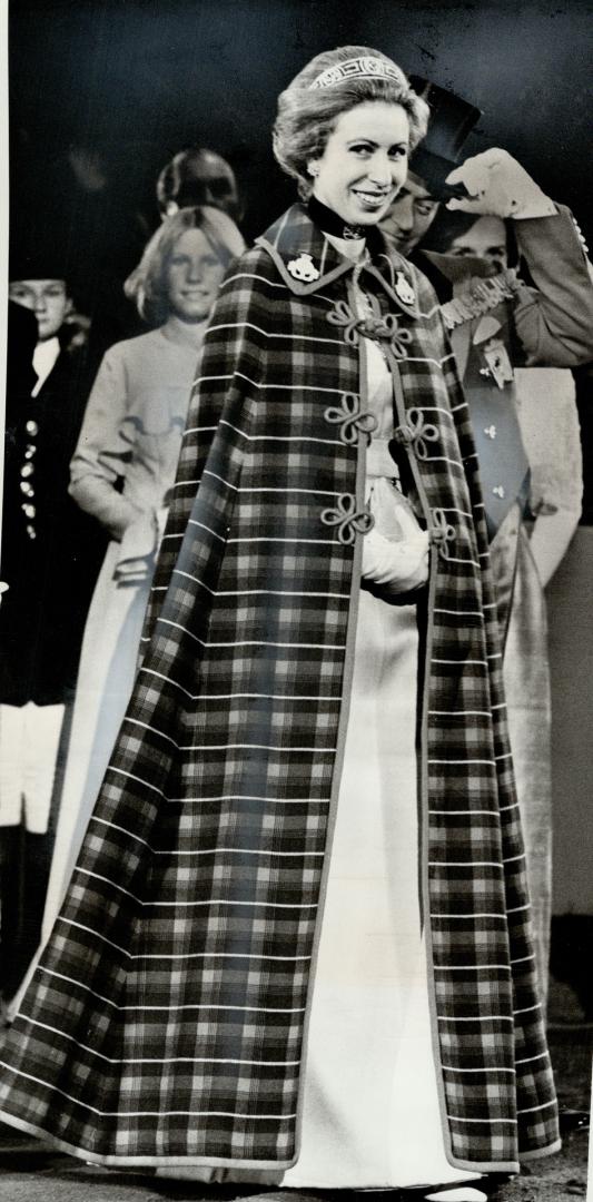 Princess Anne went to the fair in a full-length cloak, It's a cape in regimental colors of the 8th Canadian Hussars (Princess Louise's)