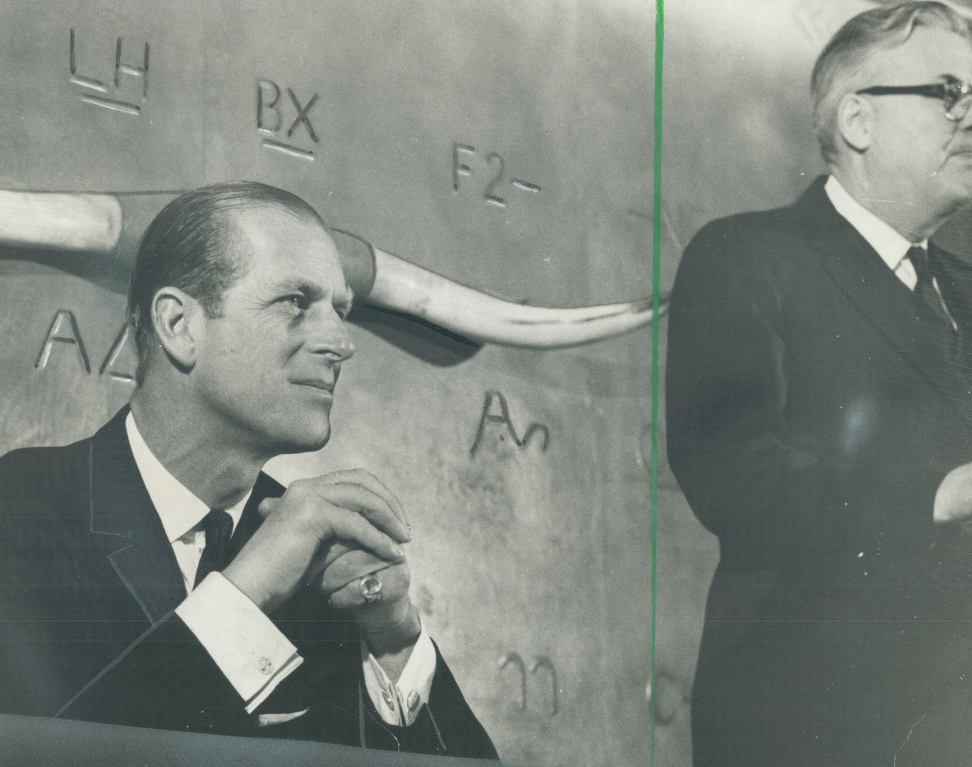 Cattle Brands used on Canadian ranches decorate wall of Alberta Room of Royal York behind Prince Philip as he listens to speech at luncheon given by R(...)