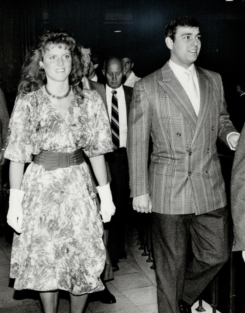 Off to the Lakehead: A beaming Duke and Duchess of York leave the Royal York Hotel this morning to fly to Thunder Bay for a tour of Old Fort William