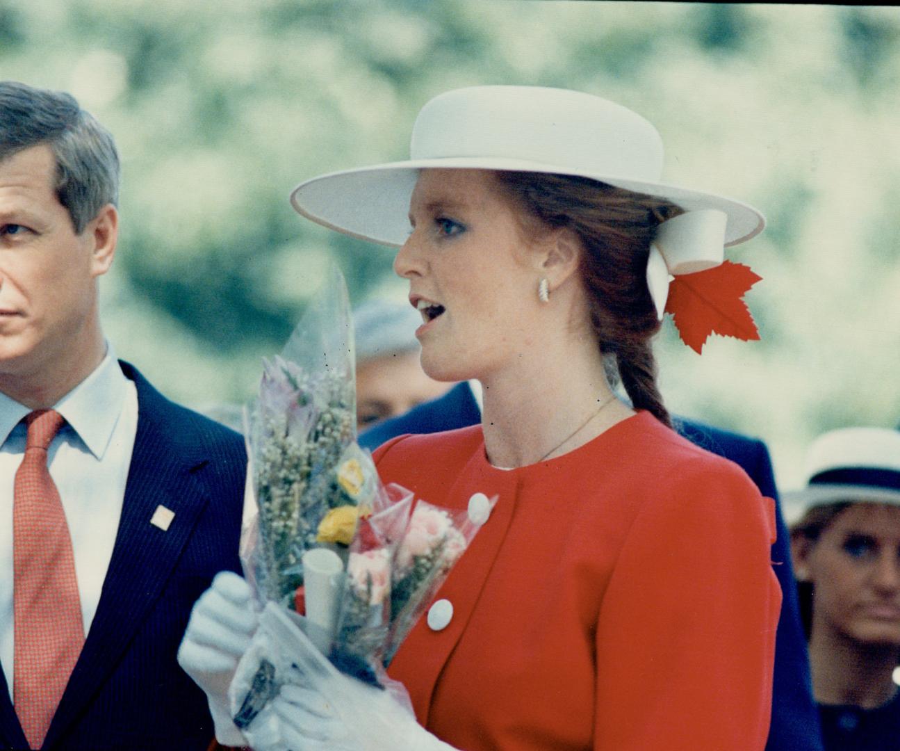 Above, a red Maple Leaf adds a patriotic touch to her braided, be-ribboned hair