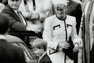 Below, she's attired in red-trimmed cream suit and matching hat she wore to church