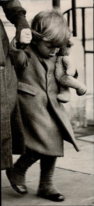 Off to the country, Little Prince Edward, son of the Duke and Duchess of Kent, holds tightly to his Teddy