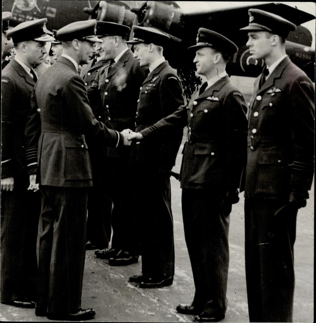 Officer commanding the R.C.A.F. Thunderbird squadron, Wing Com. C. W. Burgess, Port Credit, is greeted by the King during the recent visit of Their Majesties to units of the R.C.A.F. overseas