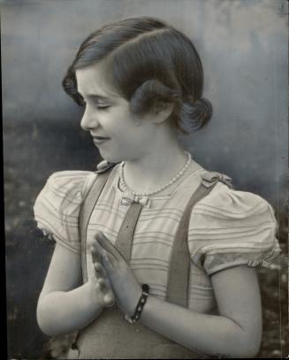 In this Candid Shot, the playful Princess claps her hands during a rest period at a photographic sitting