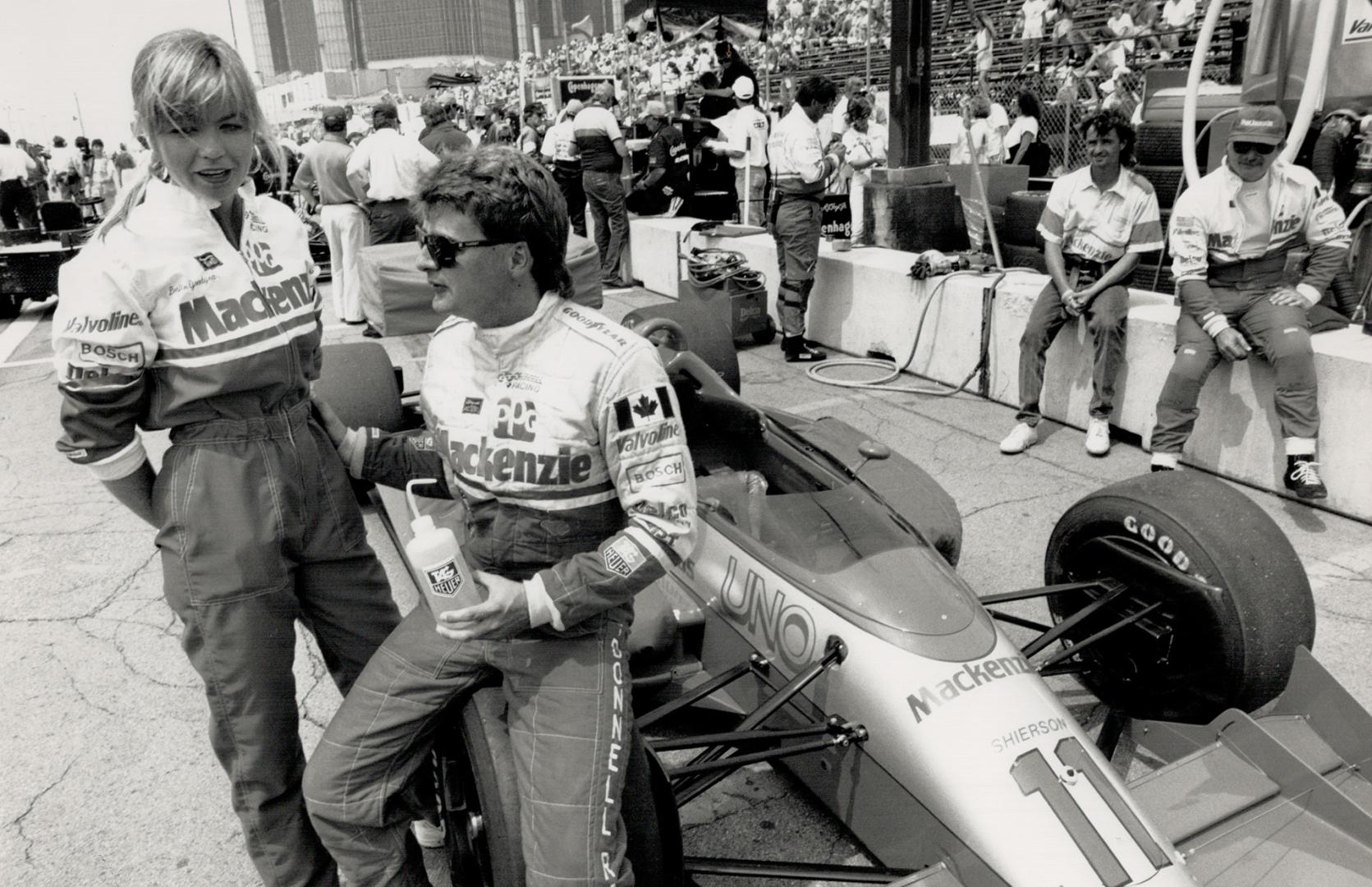 Scott Goodyear, with wife Leslie (left), has scored four Top 10 finishes so far, including an eighth at Detroit (above)