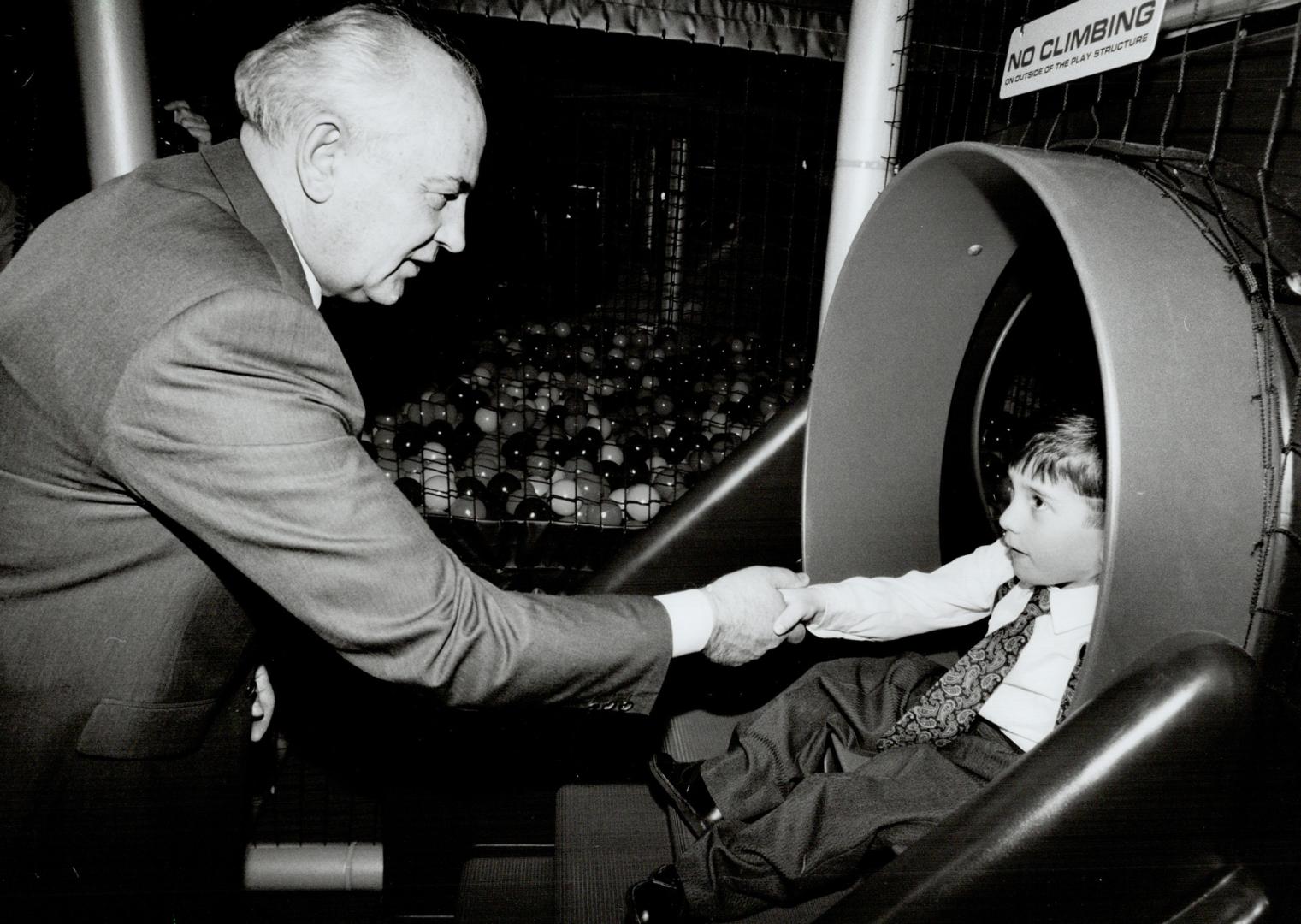 Put 'er there: Former Soviet president Mikhail Gorbachev greets new pal Alex Pinkerton, 6, yesterday at Scarborough's Variety Village on Danforth Ave