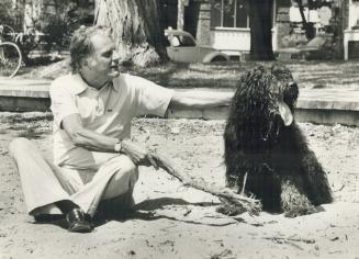 On a visit to Toronto in 1978, Graham relaxed and frolicked with a dog