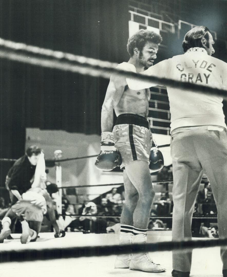 That's all: Clyde Gray is congratulated by handler as he returns to his corner after winning bout at Gardens last night on second-round TKO over Otho Thyson