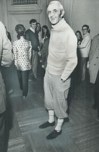 Energy Minister Joe Greene steals the sartorial spotlight from his boss, Prime Minister Pierre Trudeau, for Grey Cup