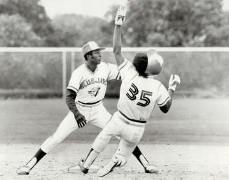 It's rookie against rookie as shortstop Alfredo Griffin takes throw to catch Ted Wilborn