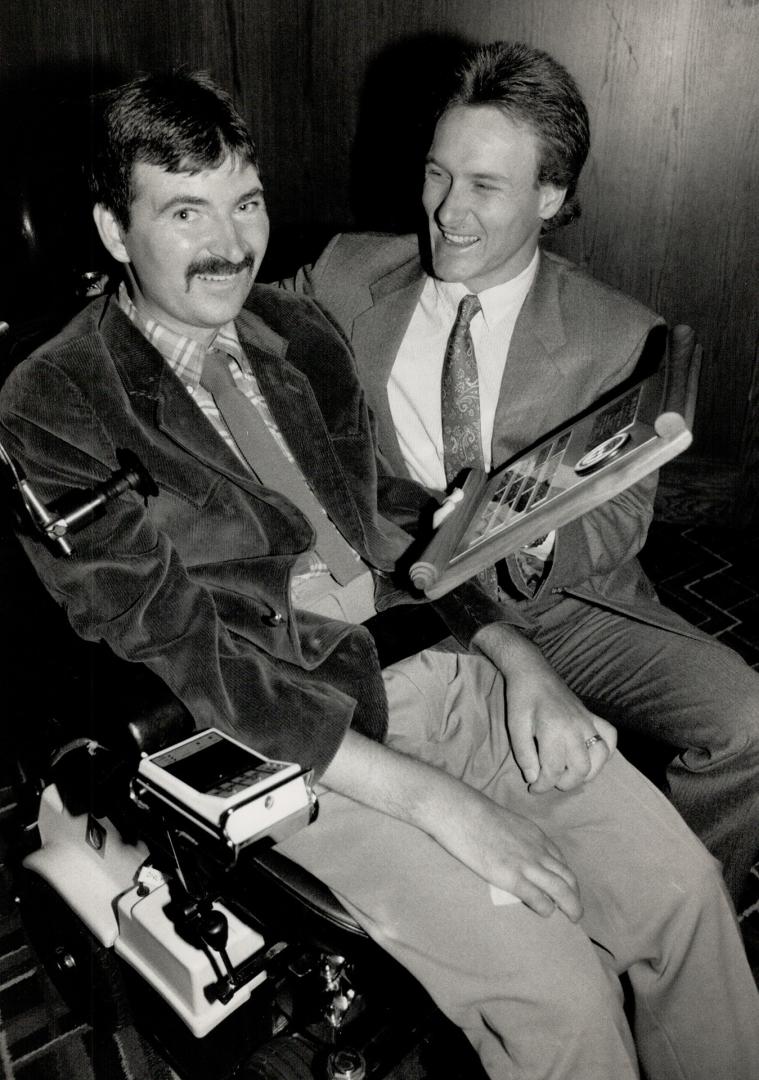 A pair of fighters. Blue Jay Kelly Gruber shows his '88 Iron Man Award to former East York ball player Gerry Hukish at a luncheon yesterday. Hukish has Lou Gehrig's disease