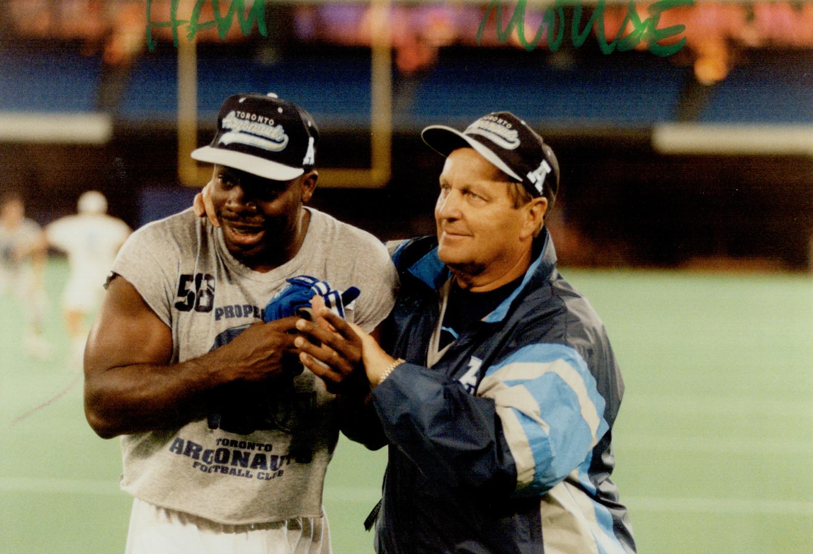 Hamming it up: Tracy Ham and offensive co-ordinator Darrel (Mouse) Davis shared a laugh as the Argos prepared for tonight's game against the Ticats