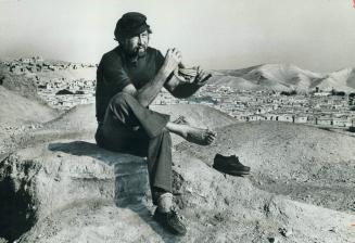 35 miles to go, Star religion editor Tom Harpur stops for a rest on the ruined walls of ancient city of Jericho, overlooking a deserted town of mud hu(...)