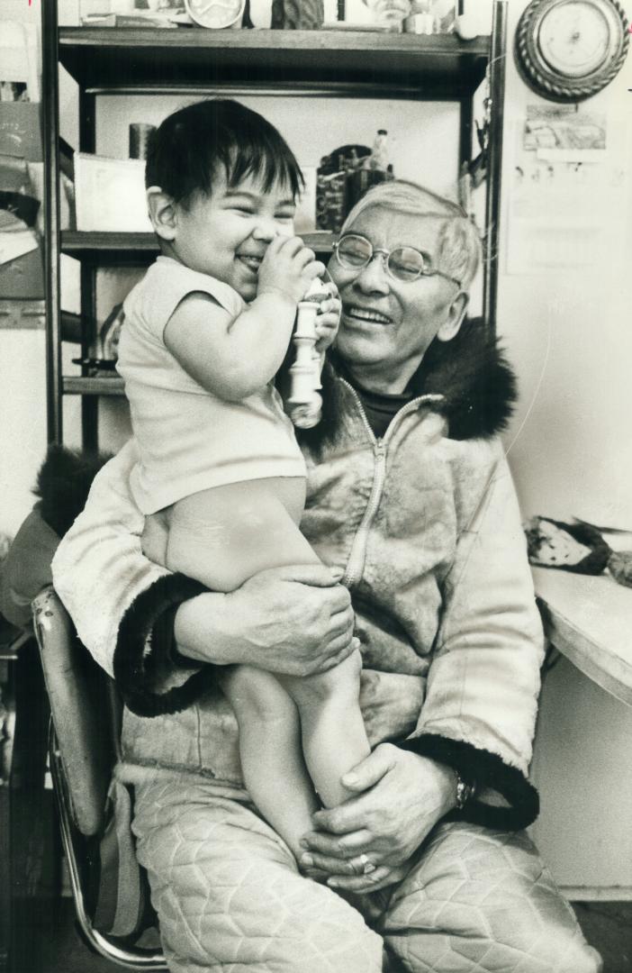 Cutting his teeth on a seal bone, Christopher, born on Christmas Day, 1976, laughs in the arms of his great-grandfather, James Kilibuk. Great love flo(...)