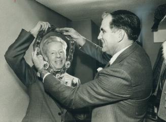 Scarborough clerk Jack Poots puts chain of office on Mayor Gus Harris at council's inaugural meeting last night