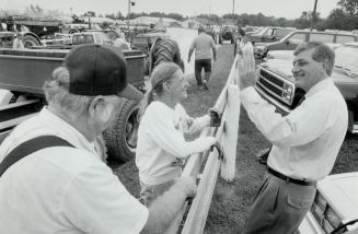 Thanks for listening: Tory leader Mike Harris, right, waves to Gerry and Doreene Todd during a visit to the Steam Era Exhibition at the Milton Fairgrounds yesterday