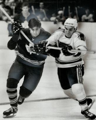 Jim Harrison, Maple Leaf centre, scrambles for puck with Andre Boudrias of St