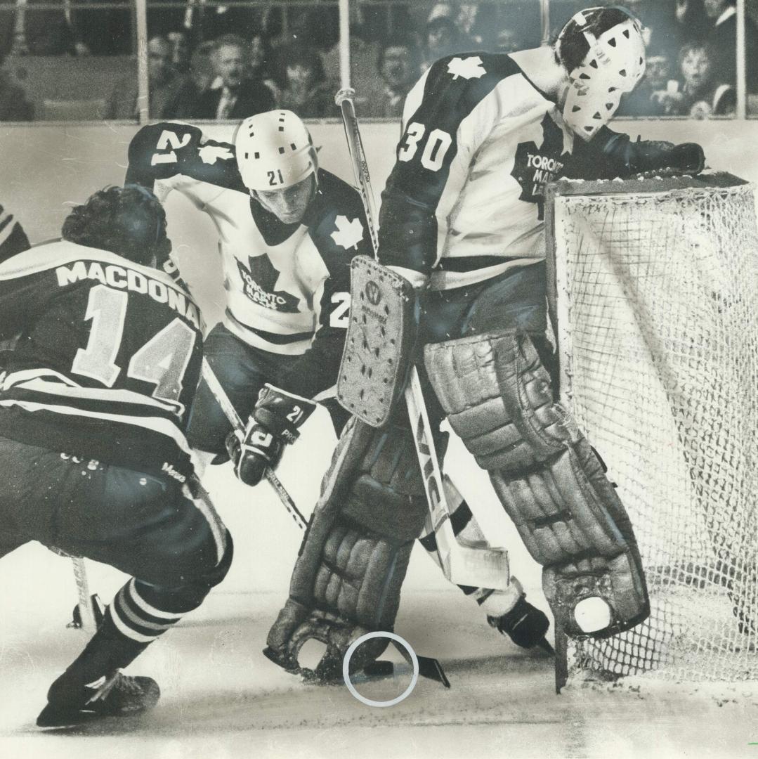 Where is it? Maple Leaf goaltender Paul Harrison can't locate the puck, but, luckily for Leafs, defenceman Borje Salming (21) could. Salming rescued p(...)