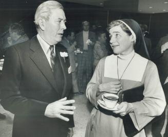 Commerce chairman Russell Harrison chats with Sister Beryl after meeting