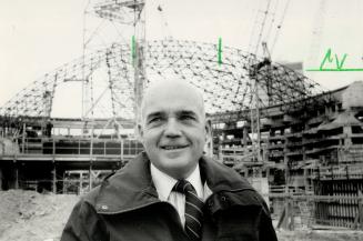 Paul Henderson, who heads Toronto's bid to be host of the 1996 Summer Games, hopes the rising SkyDome (background) will help