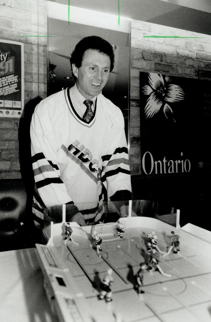 On the table: Paul Henderson, spokesman for the Esso Penalty Free Sweepstakes, unwinds with a friendly game of table-top hockey at the Gardens yesterday