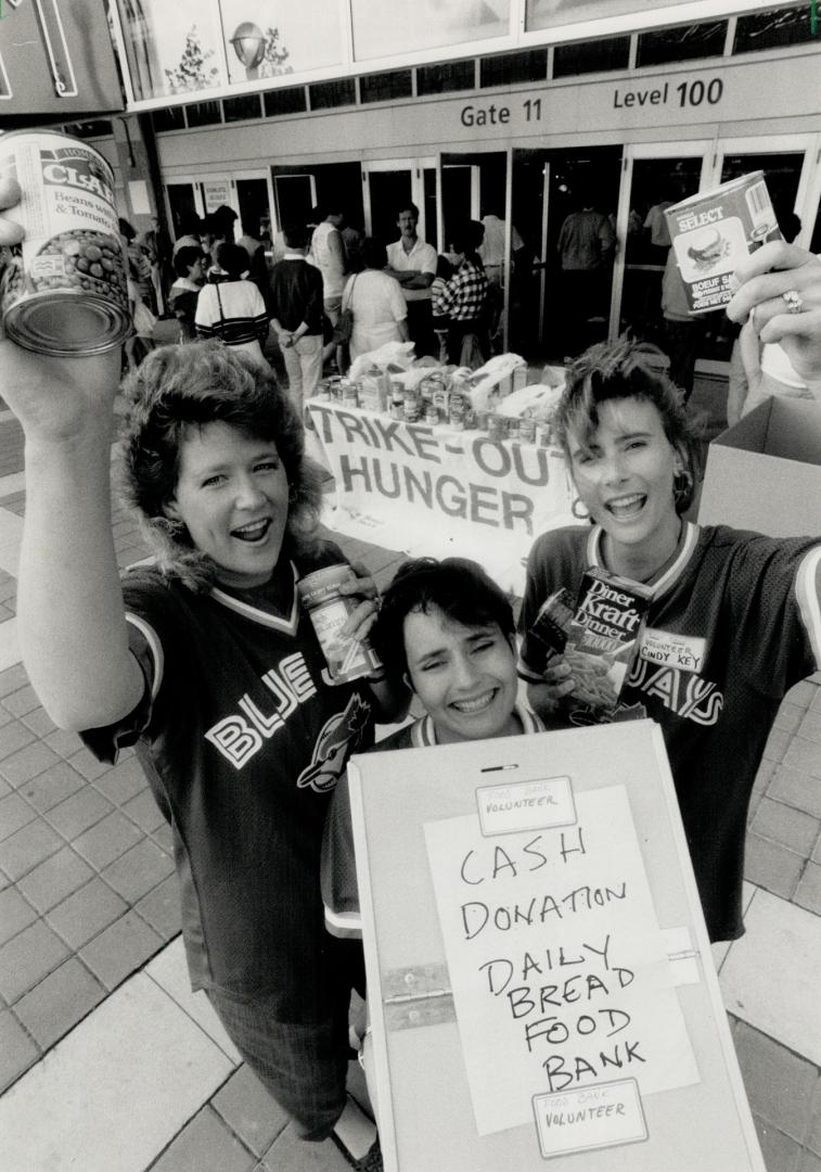 Food drive: Blue Jay wives Kathy Henke, left, Claudia Cerutti and Cindy Key show donations their drive at SkyDome has collected for Daily Bread Food Bank