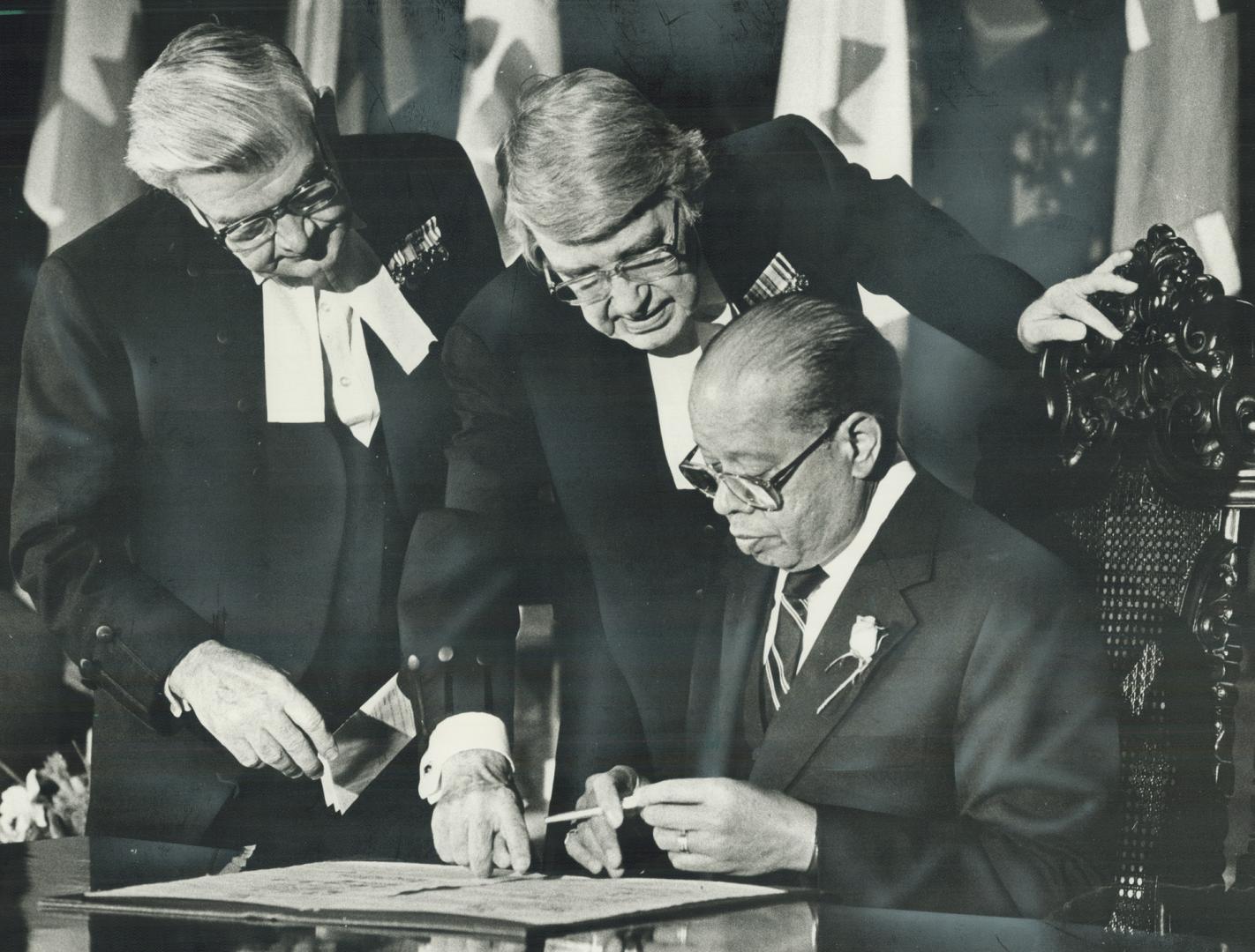 New ombudsman: Dr. Daniel Hill, former chairman of the Ontario Human Rights Commission, signs his oath of office as Ontario's new ombudsman yesterday (...)