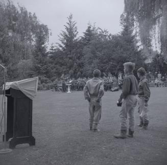 Image shows some boys listening to the band playing at the Edward Gardens opening ceremony.