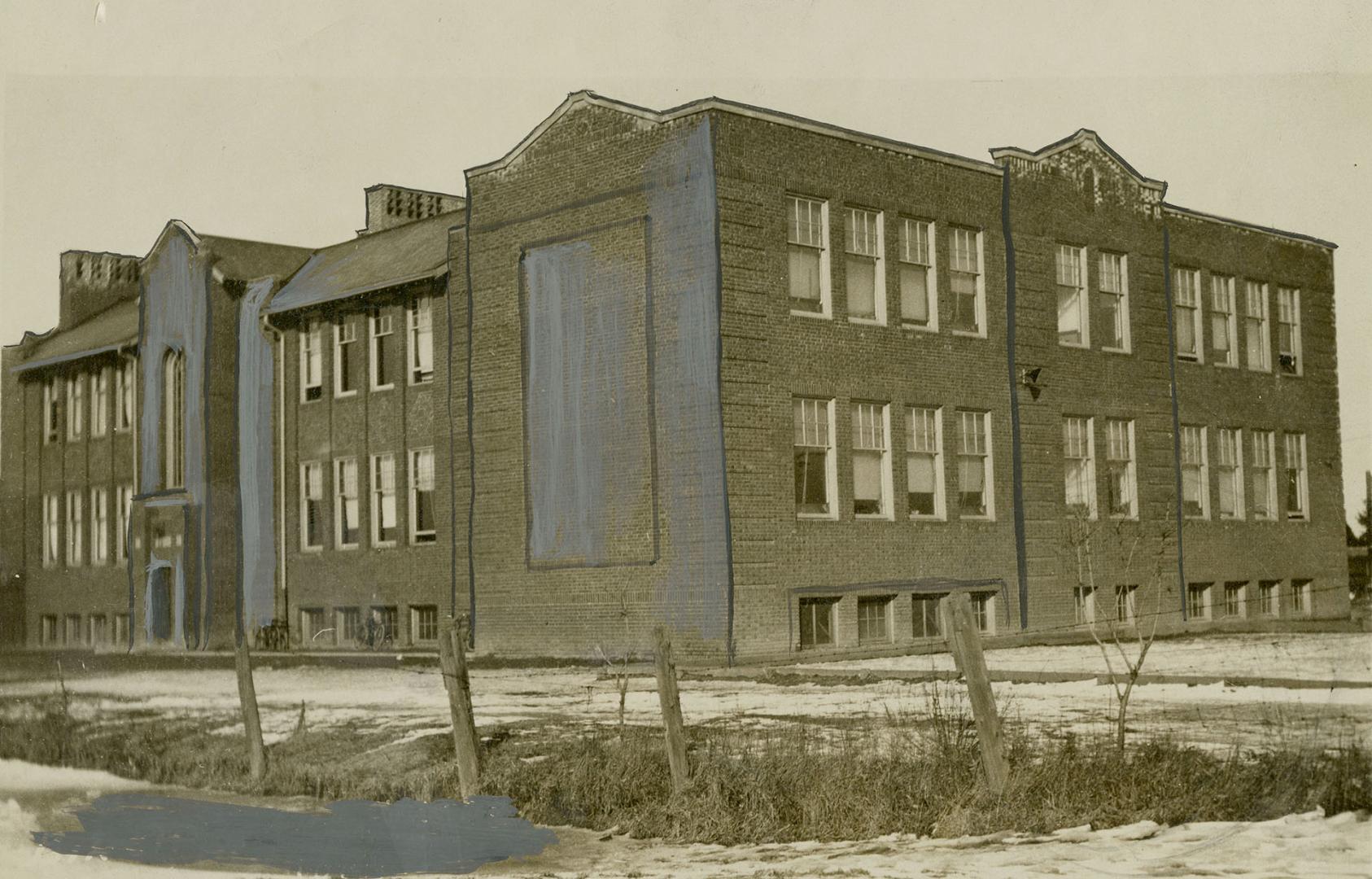 Three-storey brick building with double-hung windows.