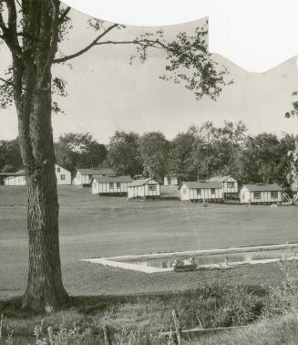 A corner of the swimming pool and some of the cottages of the Bolton Fresh Air Camp at Bolton, Ontario