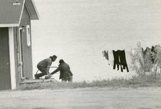 Whitedog residents at work, above, and passing time, above right