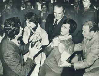 Faith healer Benny Hinn of Toronto (left) tells a cancer-stricken woman she is cured