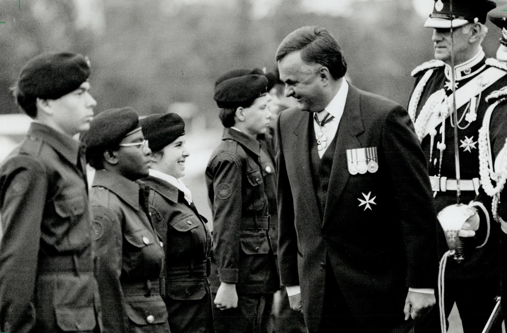 Inspectintg the troops: Governor-General Ray Hnatyshyn shares a smile with a member of the Governor-General's Horse Guard as he inspects the regiment at the University of Toronto yesterday