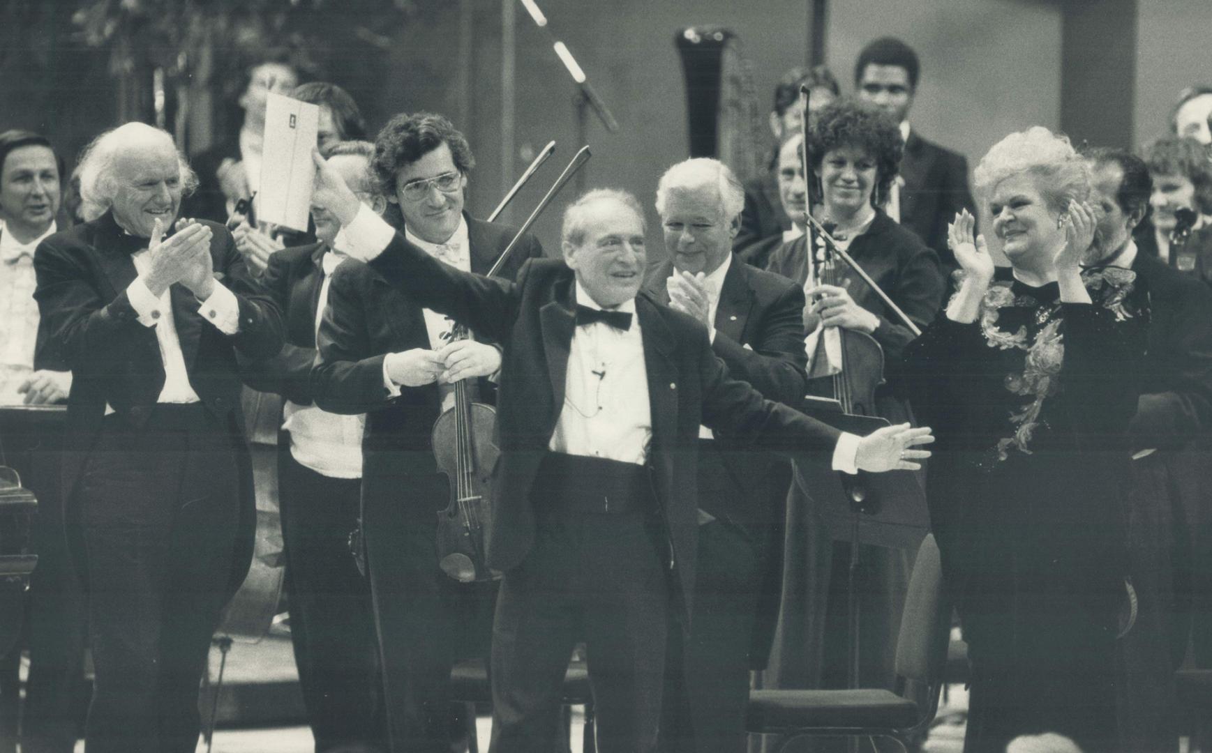 Happy impresario: Walter Homburger flings his arms wide as he responds to the acclaim of artists and 2,600 others who paid him tribute at Roy Thomson Hall last night