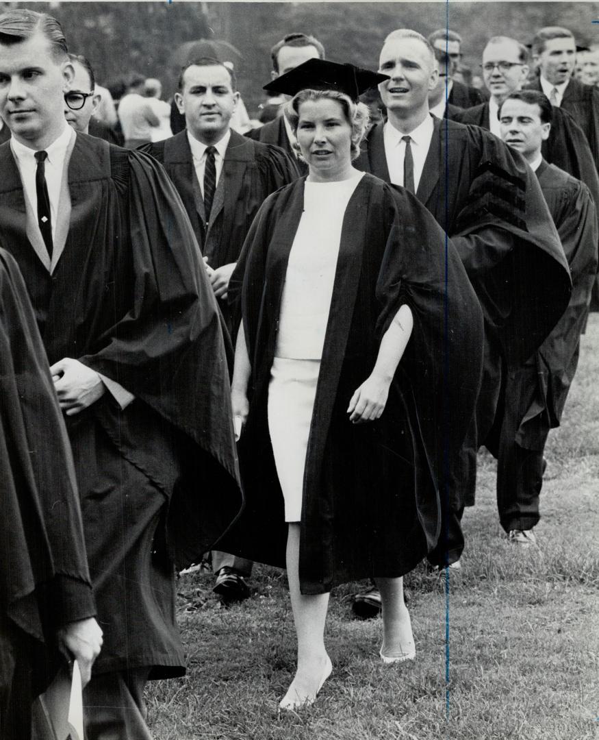 Taking her place in a man's world: Nadine's face mirrors her mixed emotions as the class walks across campus to Convocation Hall for graduation