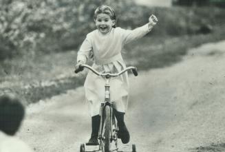 Hurray for me! That wave with her left arm is 6-year-old Brenda Huber's exuberant way of celebrating how she can use it