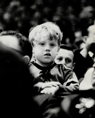 A boy waits for his dad to score