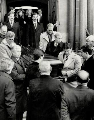 Last farewell: With his family walking behind: the casket of Punch Imlach is carried from church after his funeral