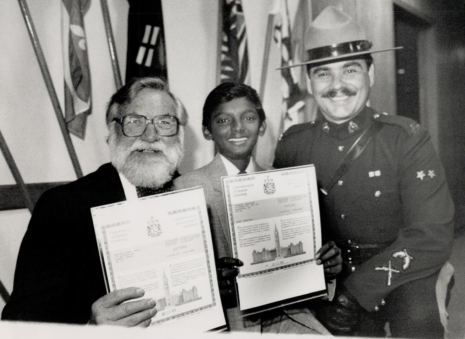 New citizens sworn in: After living in Canada for 34 years as a landed immigrant from Britain: Star photographer Reg Innell (left) became a Canadian citizen yesterday