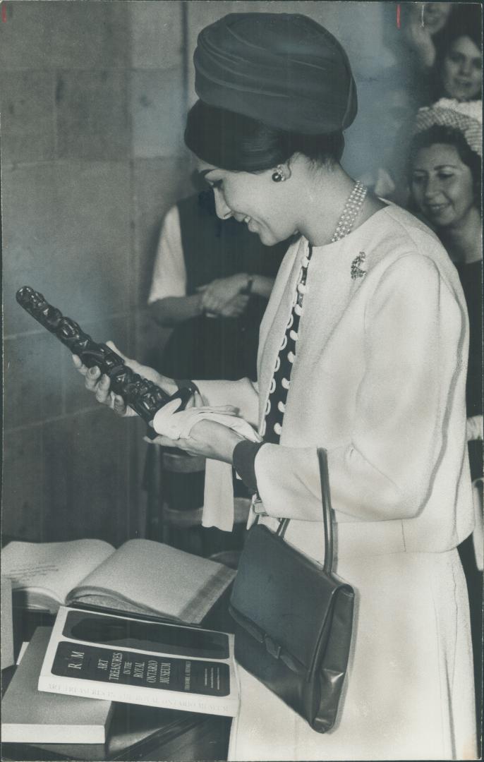 Totem carved by Haida Indians of Canada's west coast in the 19th century was given to Empress Farah of Iran yesterday following her tour of the Royal Ontario Museum