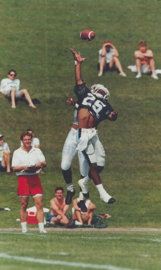 How high: Coach?: Raghib (Rocket) Ismail demonstrates his agility yesterday as he goes up for a Willie Gillus pass during training at Guelph