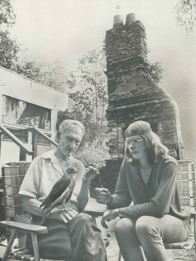 One of the Patrons of Erindale's Winding Trail Bird Sanctuary, a Northern Hawk, perches on wrist of 91-year-old naturalist Ray Ivor as he sits outside(...)